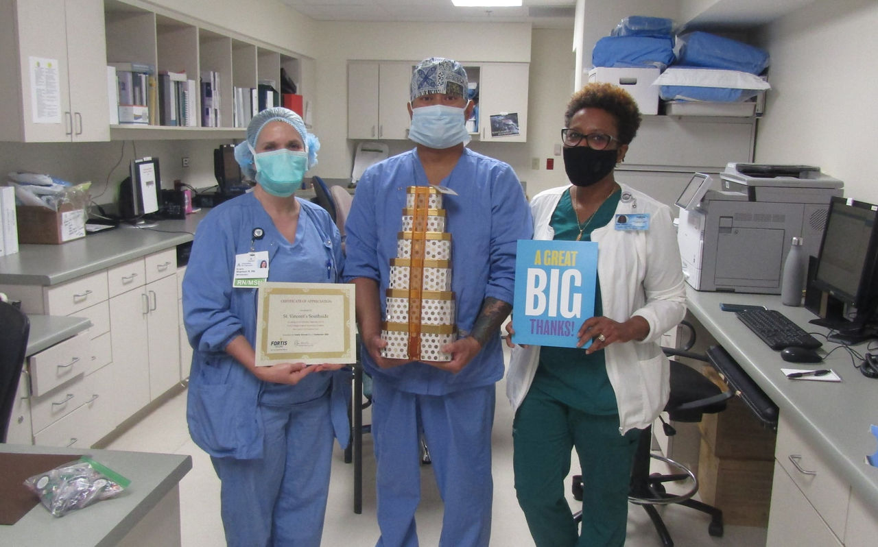 Healthcare workers holding awards and gifts