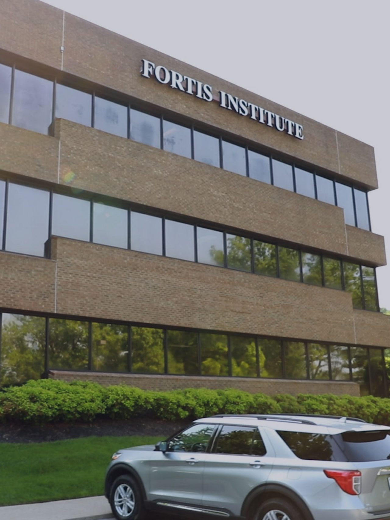 Fortis Institute exterior with parked silver SUV