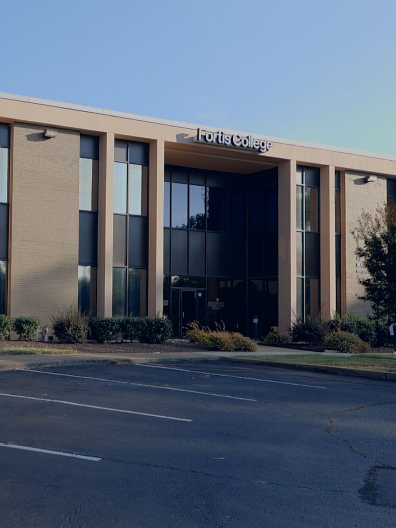 Fortis College exterior with empty parking lot